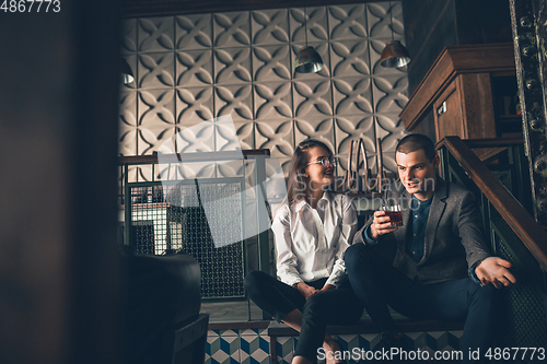 Image of Cheerful man and woman talking, enjoying, having fun at bar, cafe