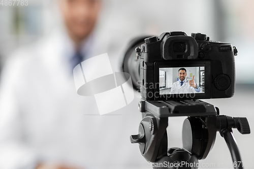 Image of male doctor recording video blog at hospital