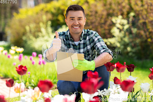 Image of man with clipboard showing thumbs up garden