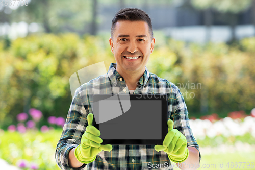 Image of happy man with tablet pc at summer garden