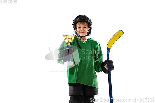 Image of Little hockey player with the stick on ice court and white studio background