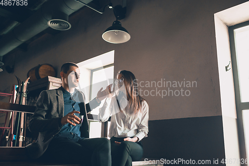 Image of Cheerful man and woman talking, enjoying, having fun at bar, cafe