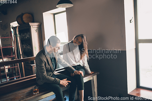 Image of Cheerful man and woman talking, enjoying, having fun at bar, cafe