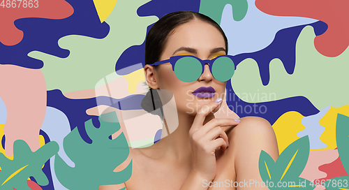Image of Portrait of a beautiful young woman with bright colorful painted design
