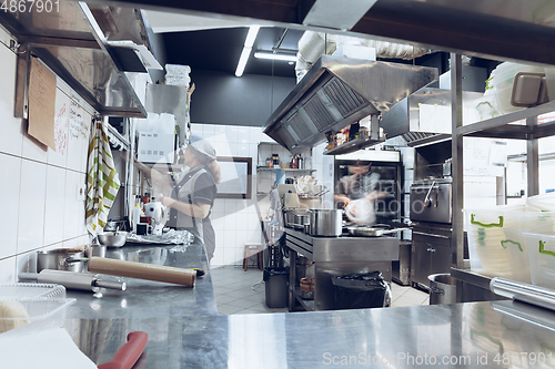 Image of Behind the scenes of brands. The chef cooking in a professional kitchen of a restaurant meal for client or delivery. Motion.