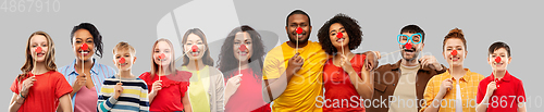 Image of group of happy smiling people with red clown noses