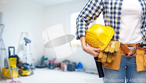 Image of woman or builder with helmet and working tools