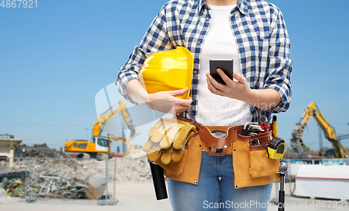 Image of woman or builder with phone and working tools