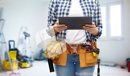 Image of woman or builder with tablet pc and working tools