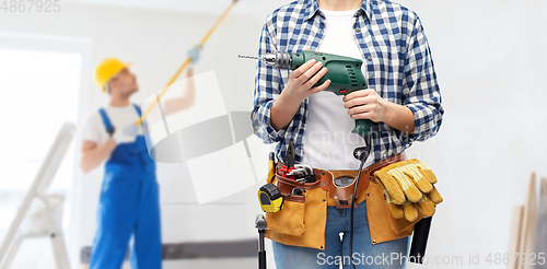 Image of woman or builder with drill and work tools