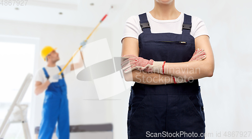 Image of close up of female painter or builder in overall