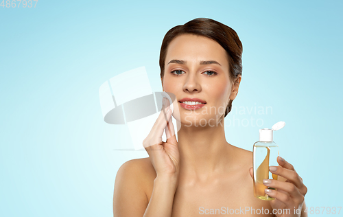 Image of young woman with toner or cleanser and cotton pad