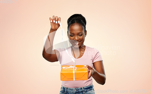 Image of happy african american woman with gift box