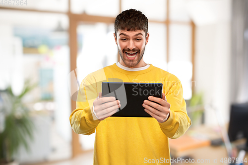 Image of smiling young man with tablet pc computer