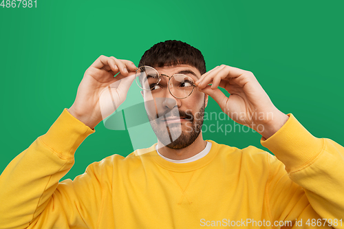 Image of goofy young man in glasses and yellow sweatshirt