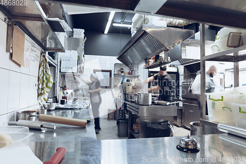 Image of Behind the scenes of brands. The chef cooking in a professional kitchen of a restaurant meal for client or delivery. Motion.