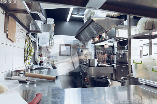 Image of Behind the scenes of brands. The chef cooking in a professional kitchen of a restaurant meal for client or delivery. Motion.