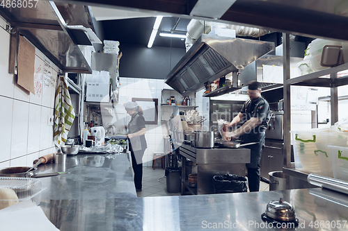 Image of Behind the scenes of brands. The chef cooking in a professional kitchen of a restaurant meal for client or delivery. Motion.