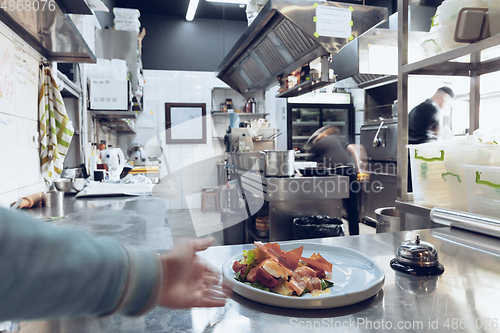 Image of Behind the scenes of brands. The chef cooking in a professional kitchen of a restaurant meal for client or delivery. Motion.