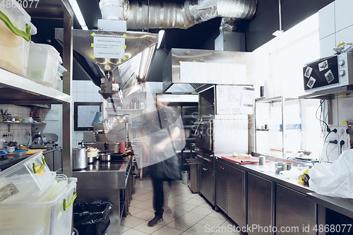 Image of Behind the scenes of brands. The chef cooking in a professional kitchen of a restaurant meal for client or delivery. Motion.