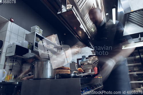 Image of Behind the scenes of brands. The chef cooking in a professional kitchen of a restaurant meal for client or delivery. Motion.