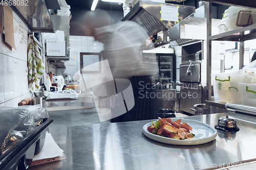 Image of Behind the scenes of brands. The chef cooking in a professional kitchen of a restaurant meal for client or delivery. Motion.
