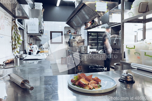 Image of Behind the scenes of brands. The chef cooking in a professional kitchen of a restaurant meal for client or delivery. Motion.