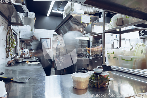 Image of Behind the scenes of brands. The chef cooking in a professional kitchen of a restaurant meal for client or delivery. Motion.