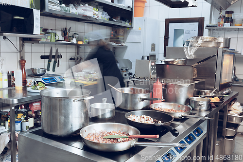 Image of Behind the scenes of brands. The chef cooking in a professional kitchen of a restaurant meal for client or delivery. Motion.