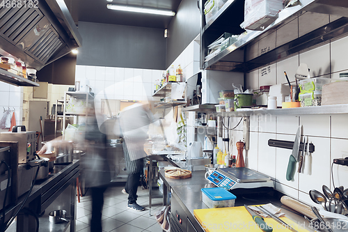 Image of Behind the scenes of brands. The chef cooking in a professional kitchen of a restaurant meal for client or delivery. Motion.