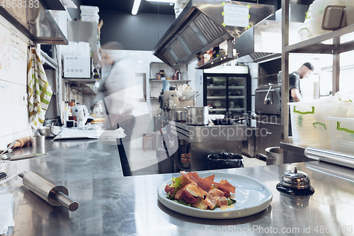 Image of Behind the scenes of brands. The chef cooking in a professional kitchen of a restaurant meal for client or delivery. Motion.