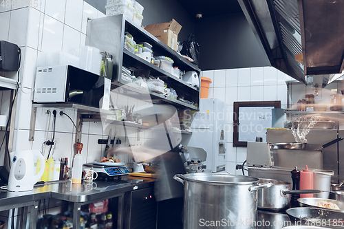 Image of Behind the scenes of brands. The chef cooking in a professional kitchen of a restaurant meal for client or delivery. Motion.