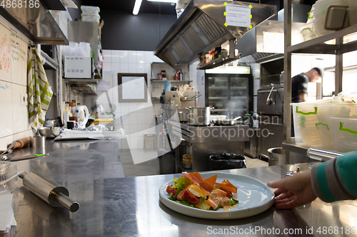 Image of Behind the scenes of brands. The chef cooking in a professional kitchen of a restaurant meal for client or delivery. Motion.