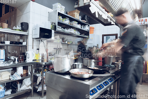 Image of Behind the scenes of brands. The chef cooking in a professional kitchen of a restaurant meal for client or delivery. Motion.