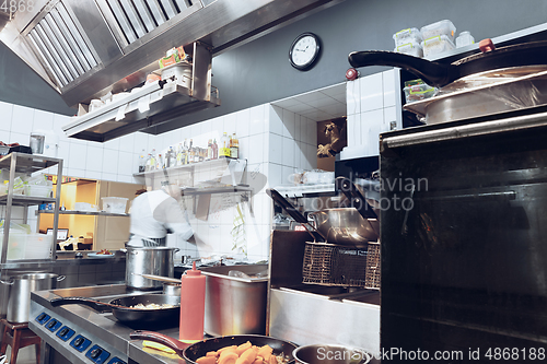 Image of Behind the scenes of brands. The chef cooking in a professional kitchen of a restaurant meal for client or delivery. Motion.