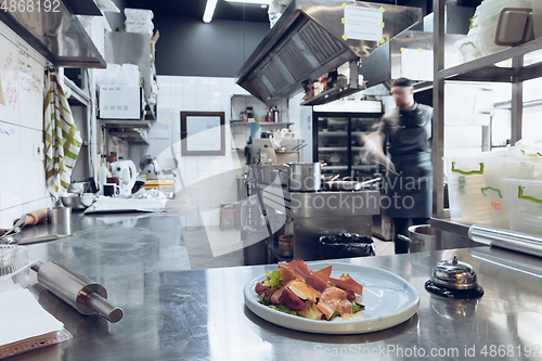 Image of Behind the scenes of brands. The chef cooking in a professional kitchen of a restaurant meal for client or delivery. Motion.