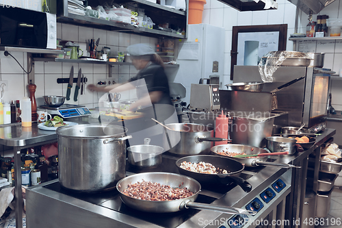 Image of Behind the scenes of brands. The chef cooking in a professional kitchen of a restaurant meal for client or delivery. Motion.