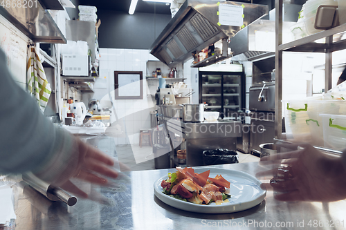 Image of Behind the scenes of brands. The chef cooking in a professional kitchen of a restaurant meal for client or delivery. Motion.