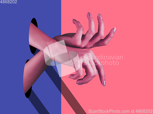 Image of Bright painted hands touching by fingers. Contemporary art collage.