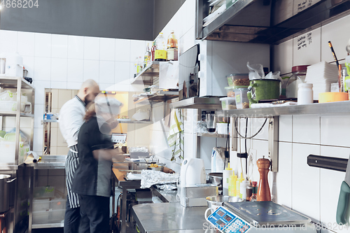 Image of Behind the scenes of brands. The chef cooking in a professional kitchen of a restaurant meal for client or delivery. Motion.