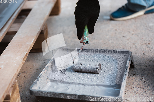 Image of Close up of hand of repairman, professional builder working indoors, repairing