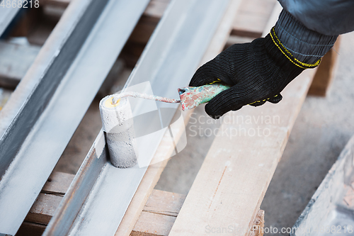 Image of Close up of hand of repairman, professional builder working indoors, repairing