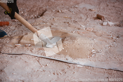 Image of Close up of hand of repairman, professional builder working indoors, repairing