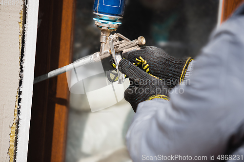 Image of Close up of hand of repairman, professional builder working indoors, repairing