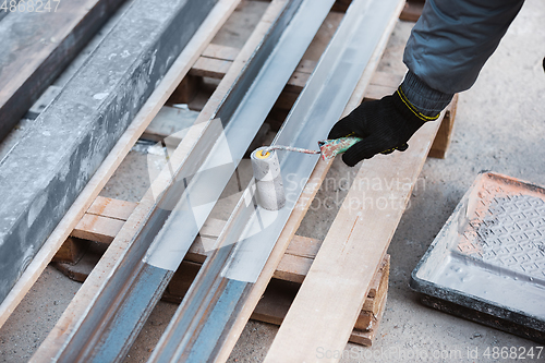 Image of Close up of hand of repairman, professional builder working indoors, repairing