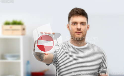 Image of young man showing stop sign