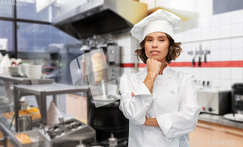 Image of female chef in toque thinking at kebab shop