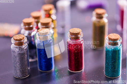 Image of set of different color glitters in bottles