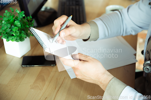 Image of Close up of caucasian doctor consulting for patient, explaining recipe for drug, working in cabinet