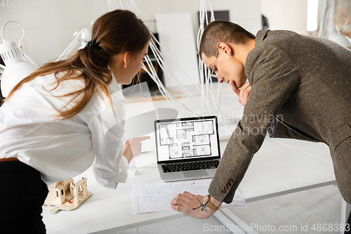 Image of Female estate agent showing new home to a young man after a discussion on house plans, moving, new home concept